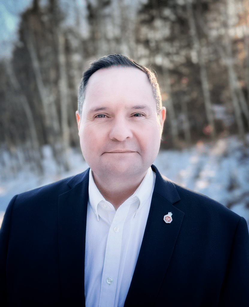 Man in suit with lapel pin outdoors in winter