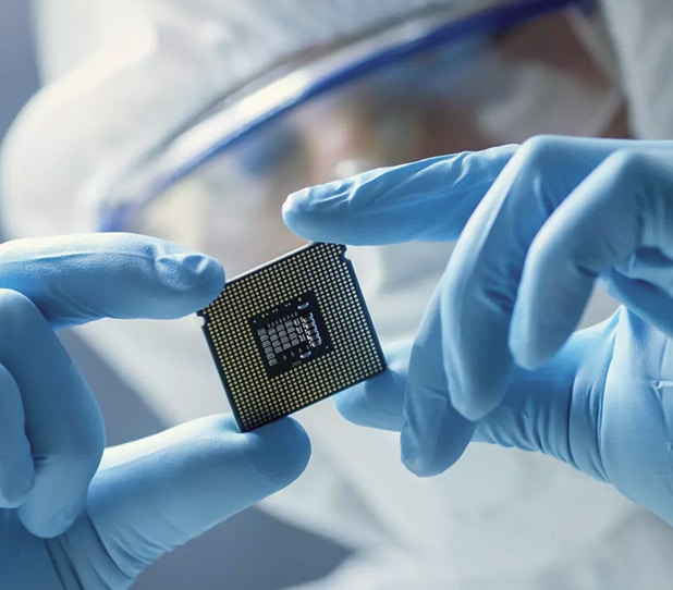 Scientist holding microprocessor chip in lab